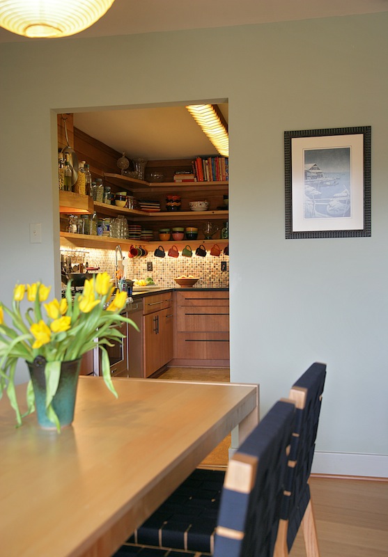 green kitche uses recylced wood shelving and bar top